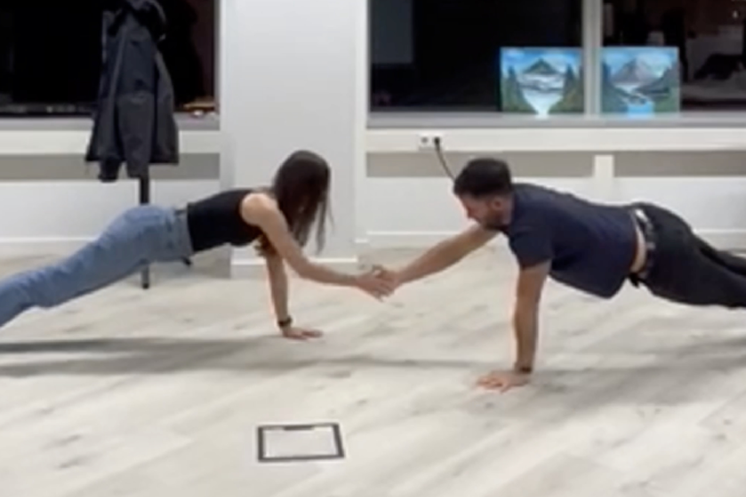 A guy and a girl doing pushups